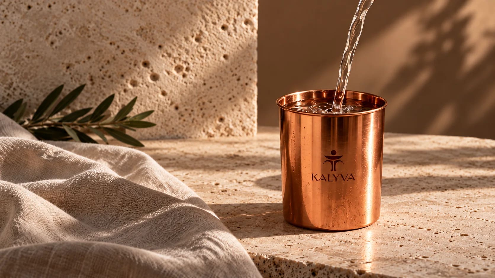 Water pouring into a KALYVA copper tumbler